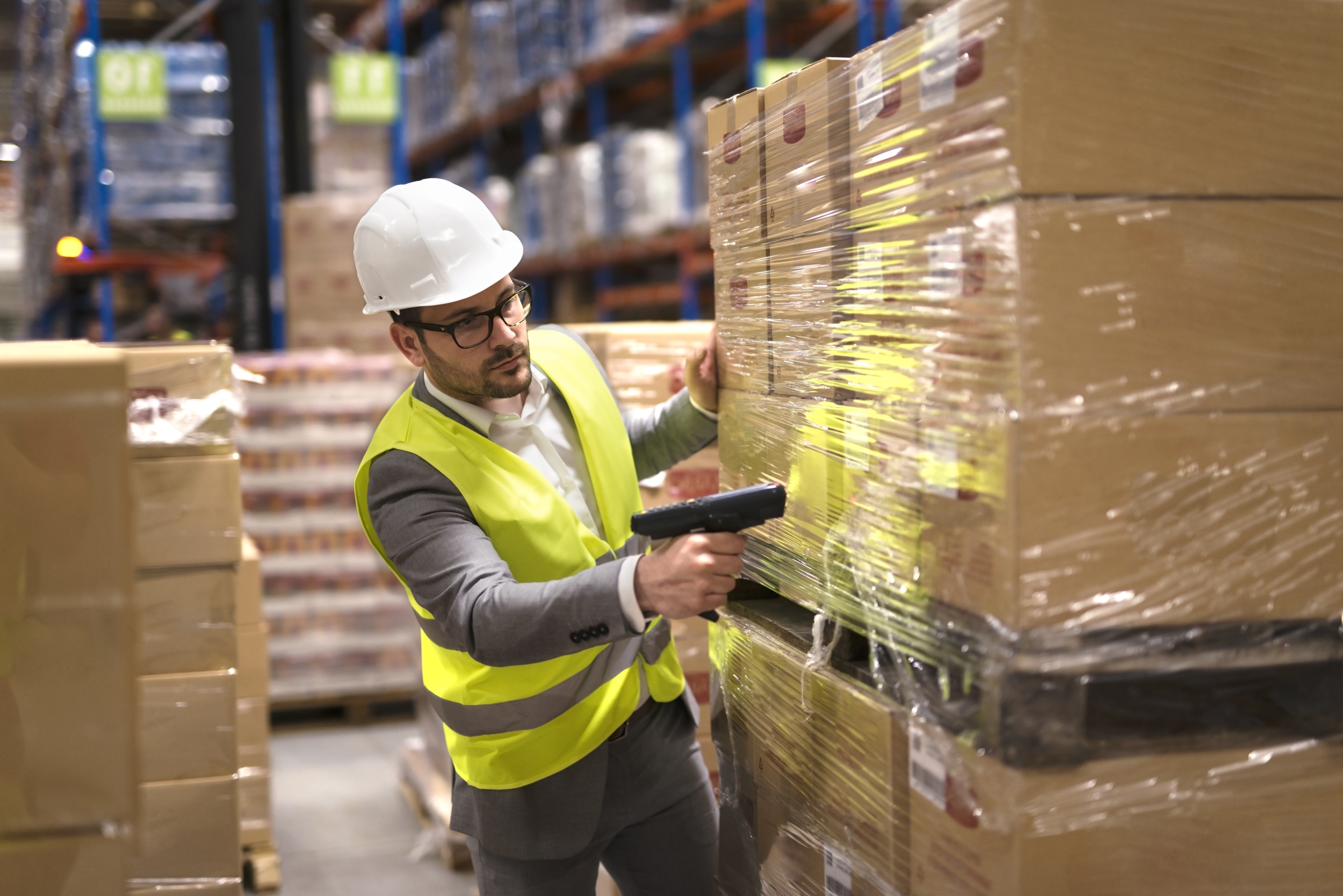 1 male-warehouse-worker-using-bar-code-scanner-analyze-newly-arrived-goods-further-placement-storage-department.jpg