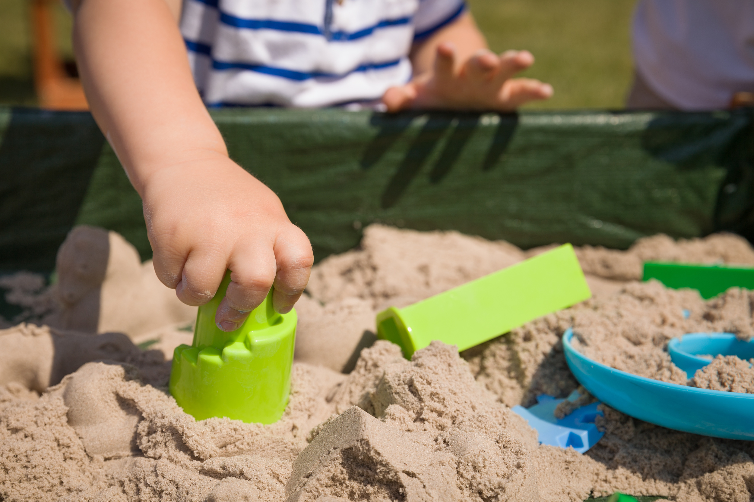 toddler-s-hands-playing-with-kinetic-sand-outdoors-child-making-shapes-lifestyle-summer-concept.jpg