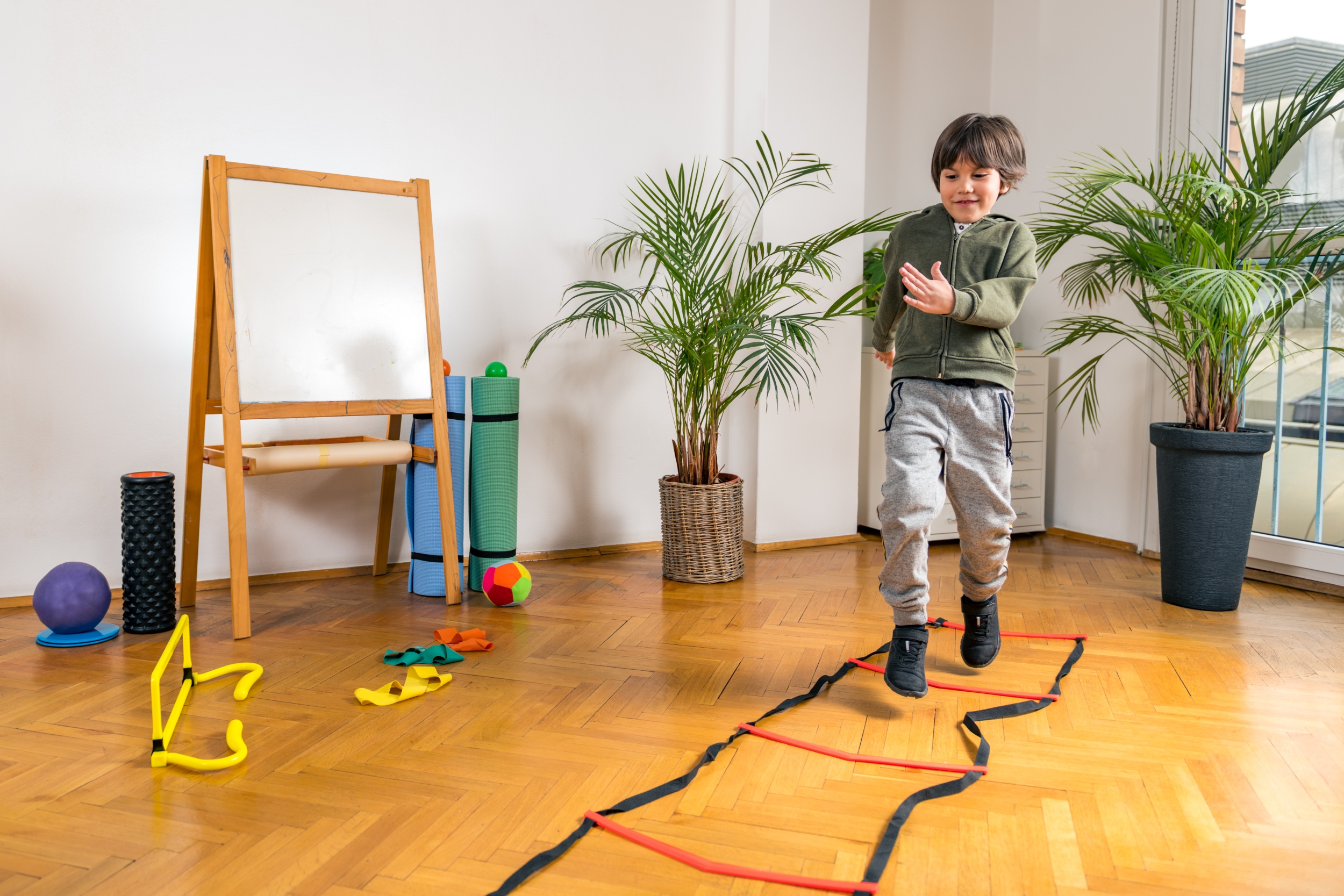 3 boy-jumping-ladders-indoors.jpg