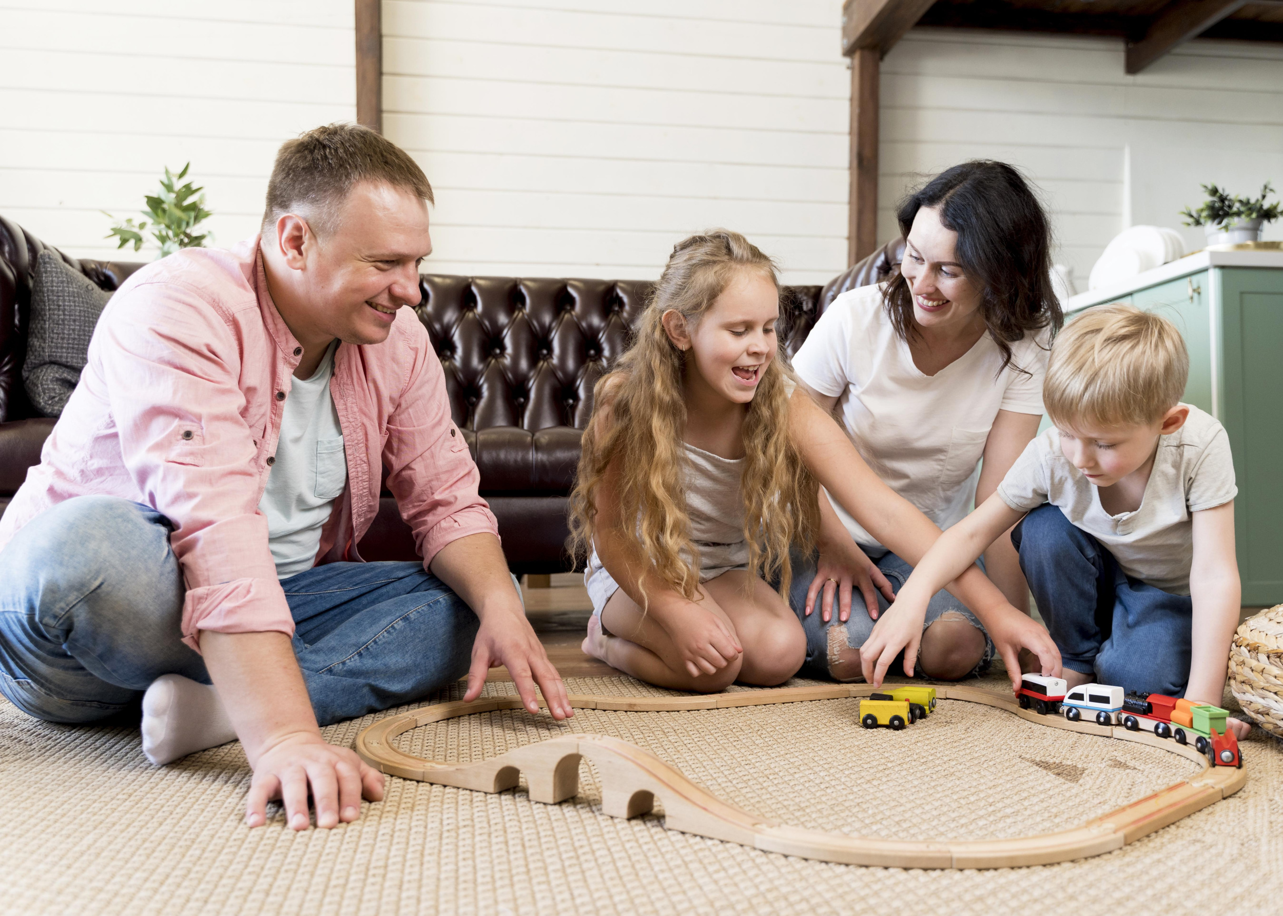 full-shot-family-playing-with-train.jpg