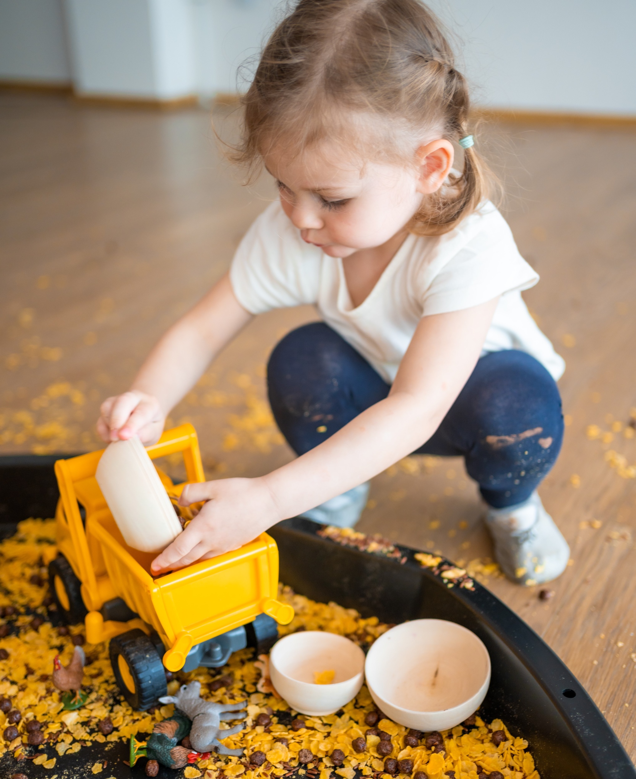 2 little-girl-playing-with-sensory-flakes-sandbox-playing-sensory-development-experiences-themed-activities-with-children-fine-motor-skills-development.jpg