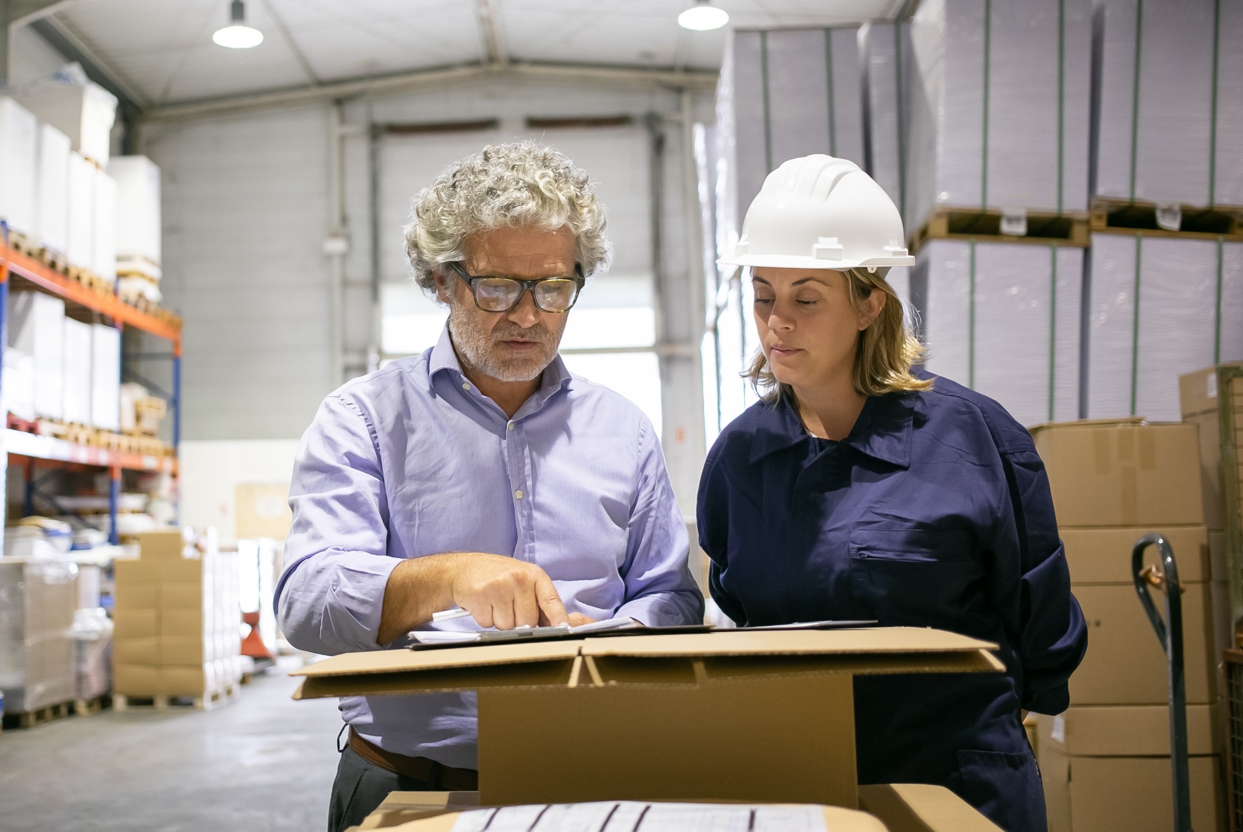 2 safety-inspector-consulting-female-logistic-worker-while-completing-form-warehouse-copy-space-front-view-labor-inspection-concept.jpg