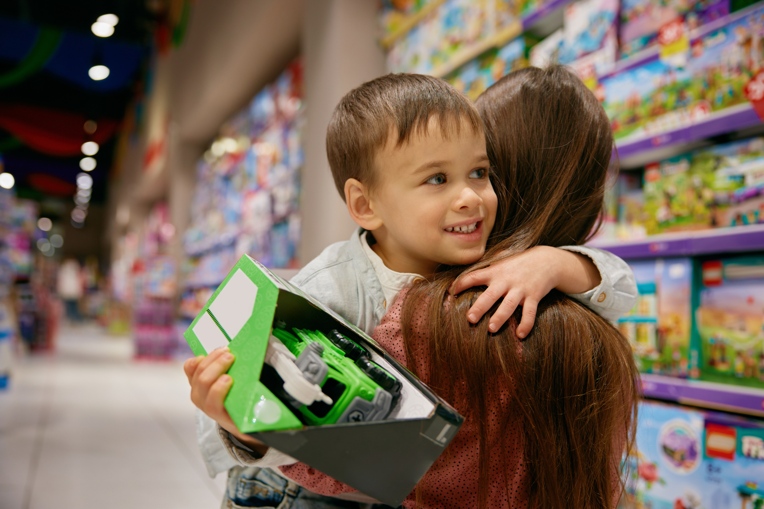 3 portrait-happy-son-hugging-mother-toys-store.jpg