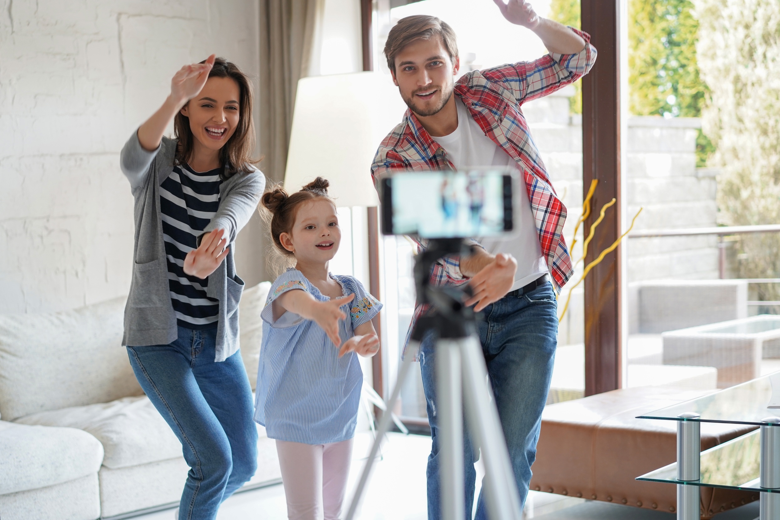 2 happy-young-family-dancing-home-with-his-little-cute-daugther-shooting-video.jpg