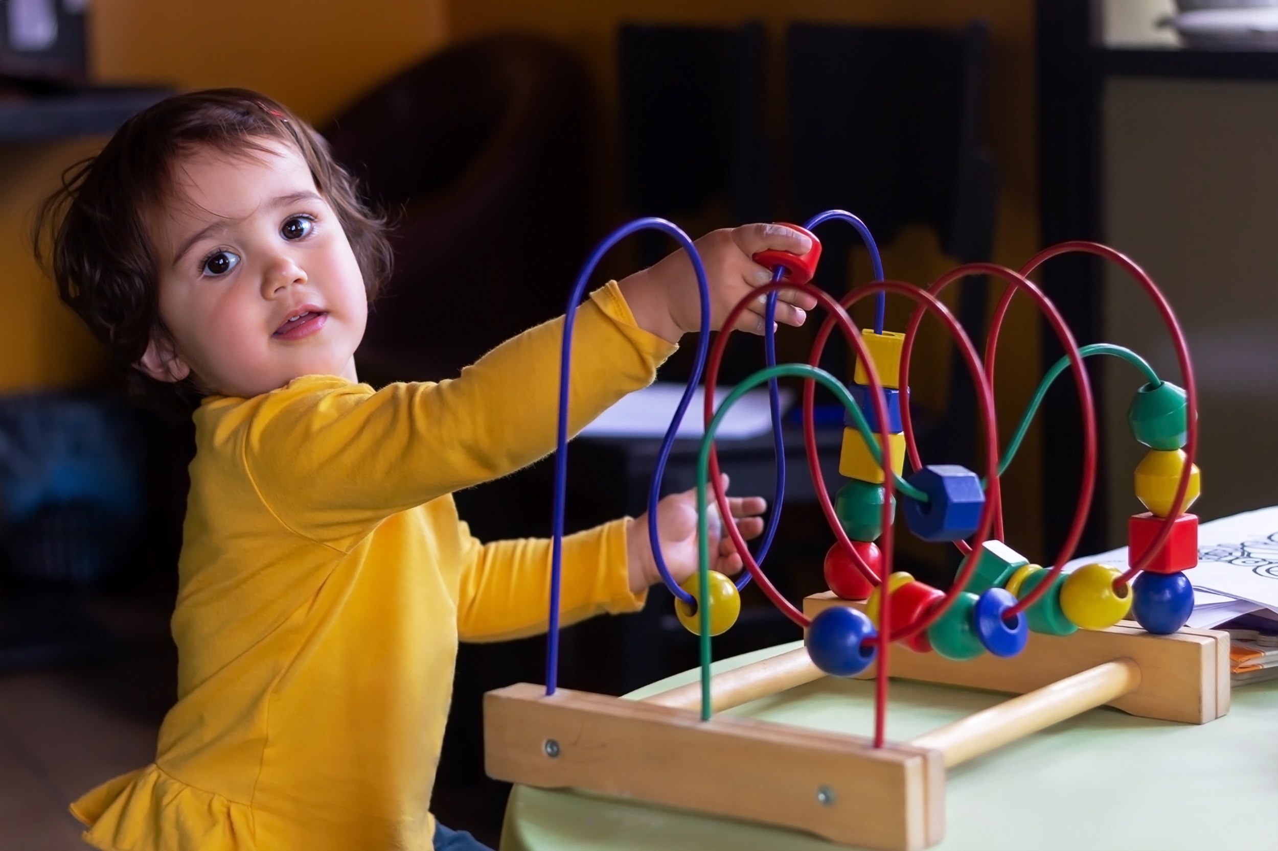 1 little-baby-girl-is-playing-with-educational-game-wooden-cubes-balls.jpg
