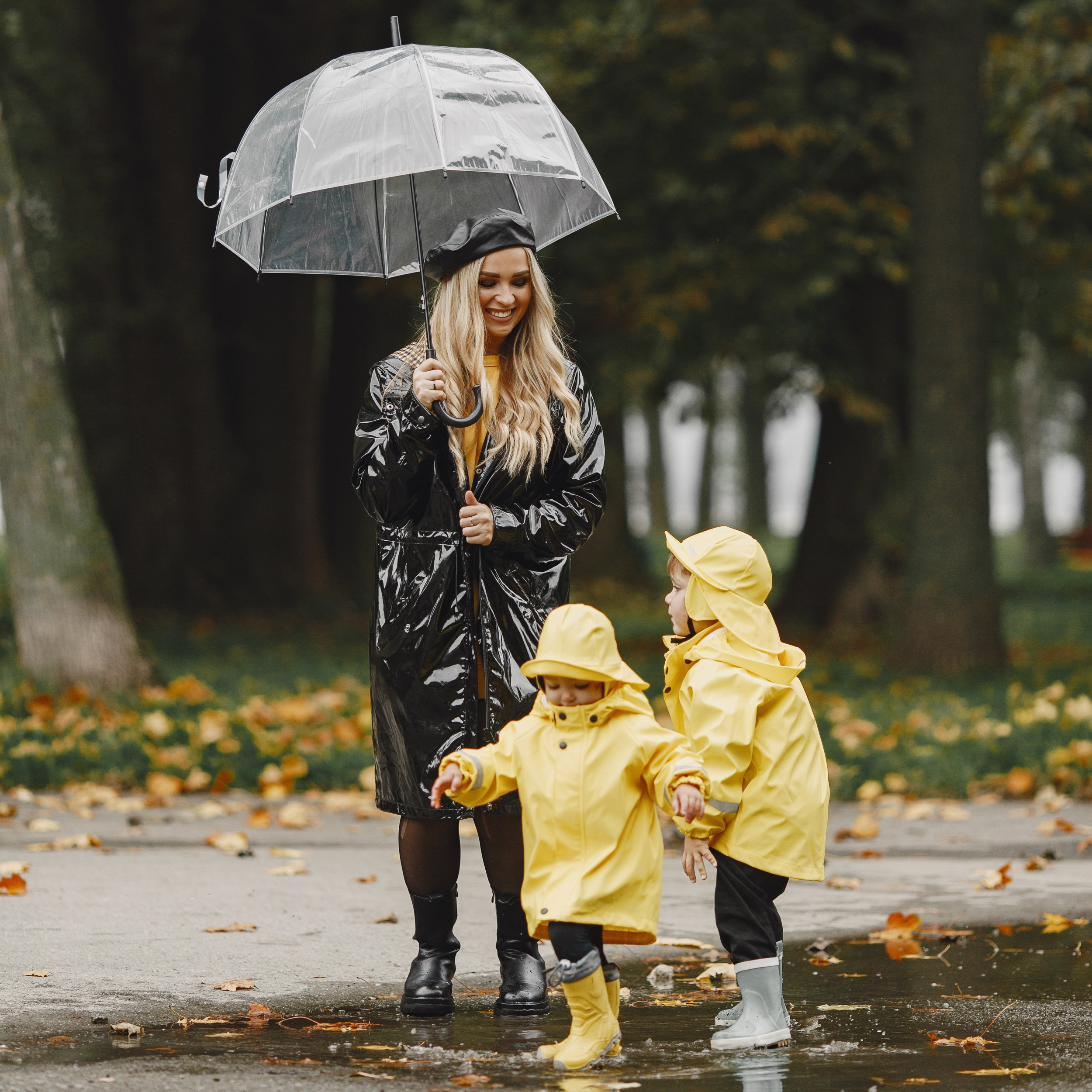 family-rainy-park-kids-yellow-raincoats-woman-black-coat.jpg