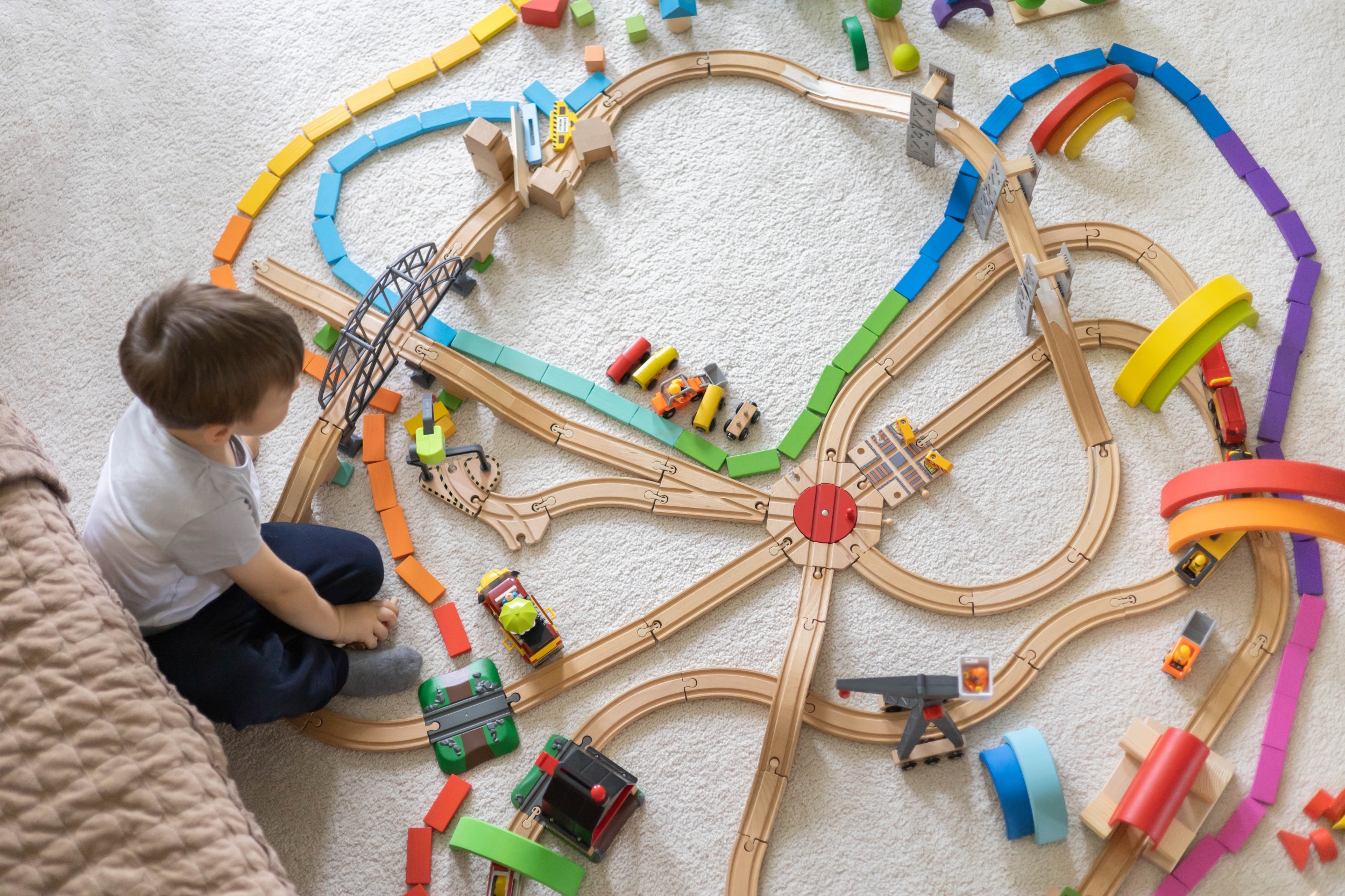 3 preschool-baby-boy-playing-wooden-montessori-materials-rainbow-arch-railways-childish-room-top-vi (1).jpg