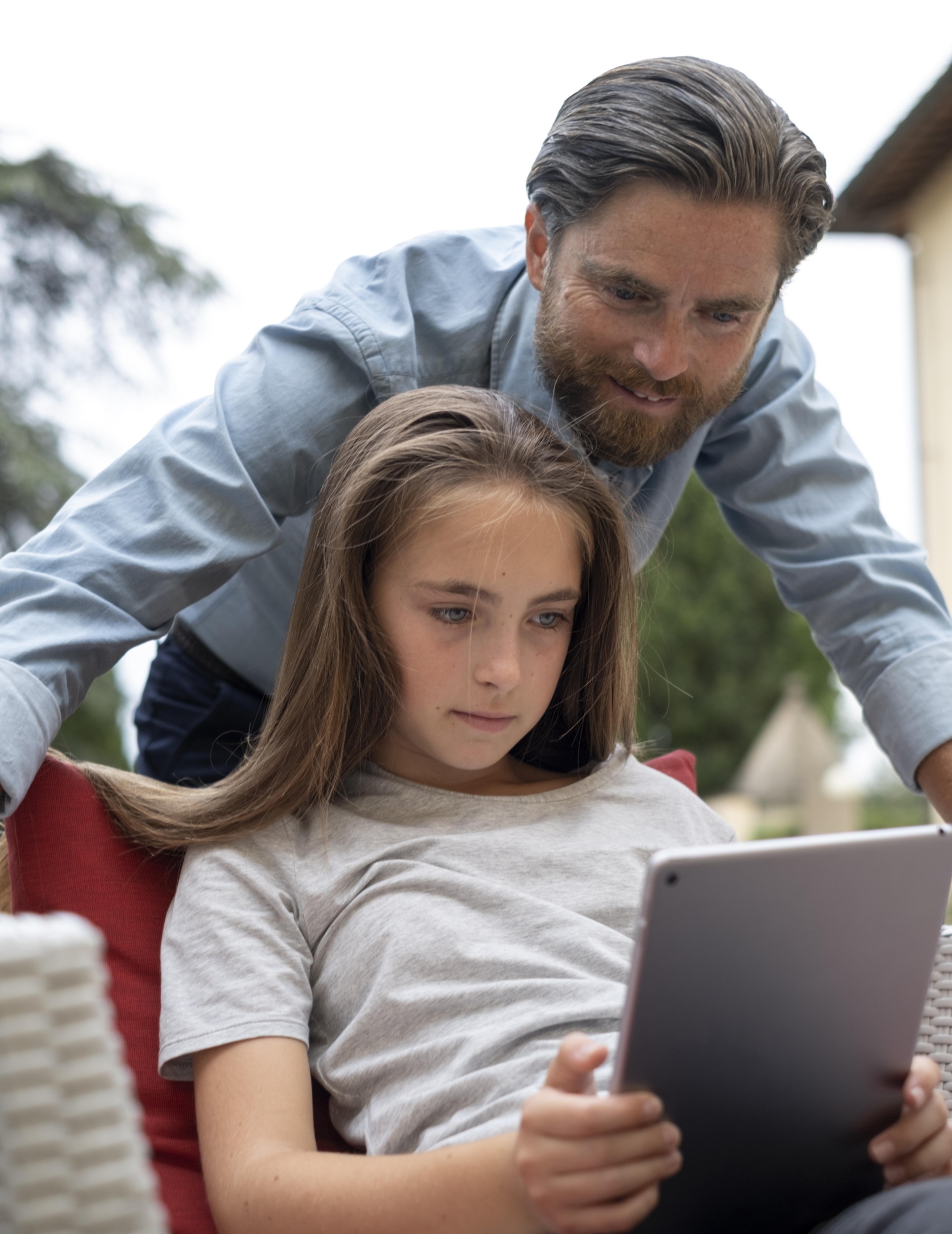 2 medium-shot-father-girl-with-device.jpg