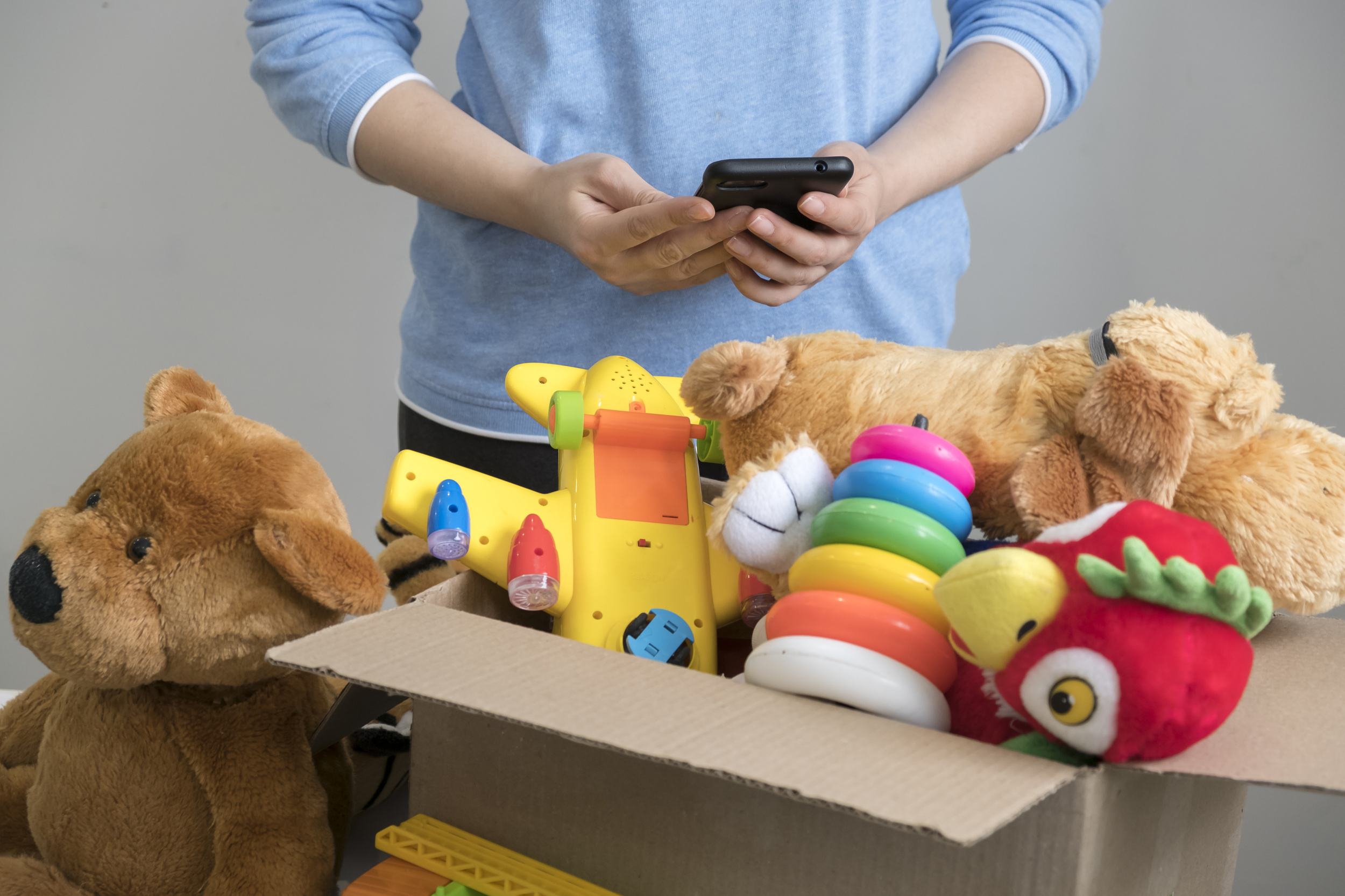 4 volunteer-holding-donation-box-with-old-toys.jpg