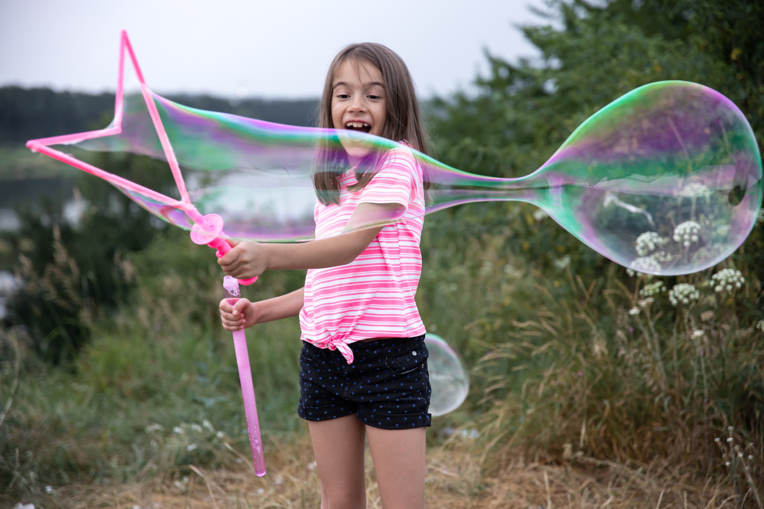 01 little-cheerful-girl-plays-with-big-soap-bubbles-nature.jpg
