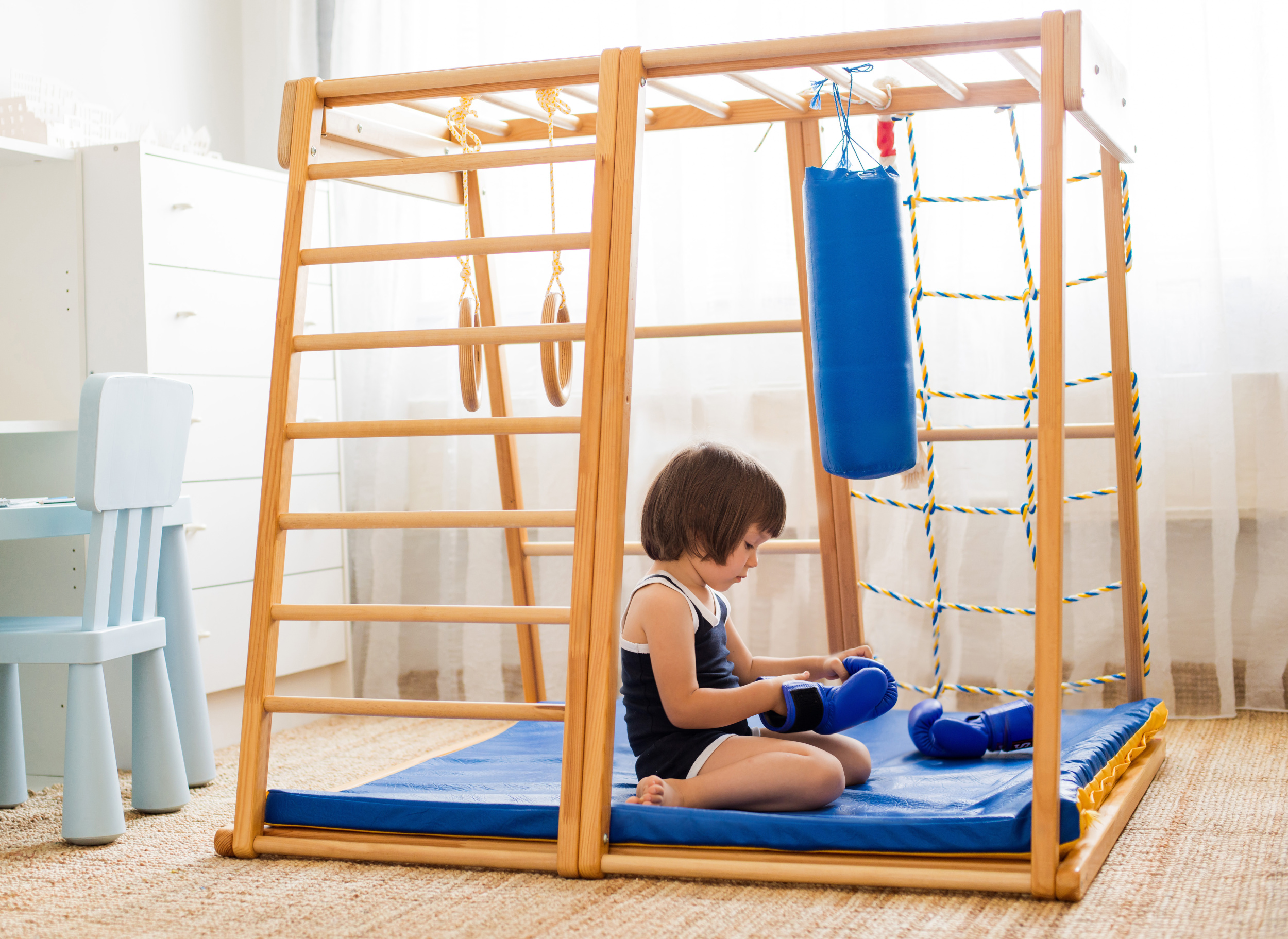 small-child-is-engaged-boxing-wooden-home-sports-complex-girl-boxing-gloves-hits-pear.jpg