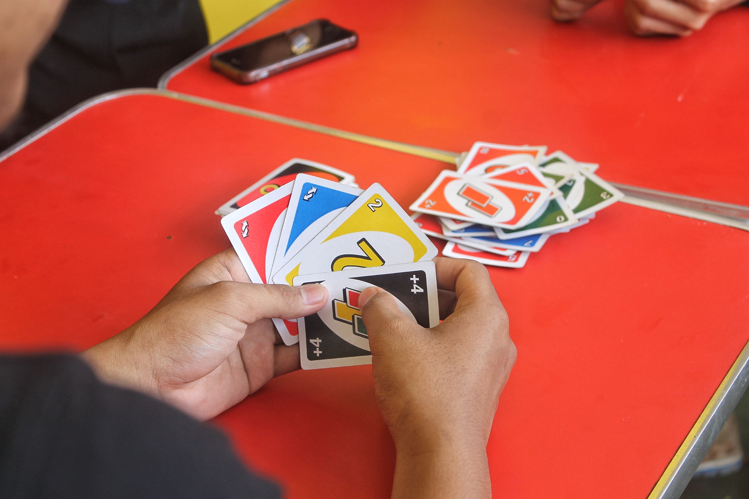 01 midsection-man-playing-cards-table.jpg
