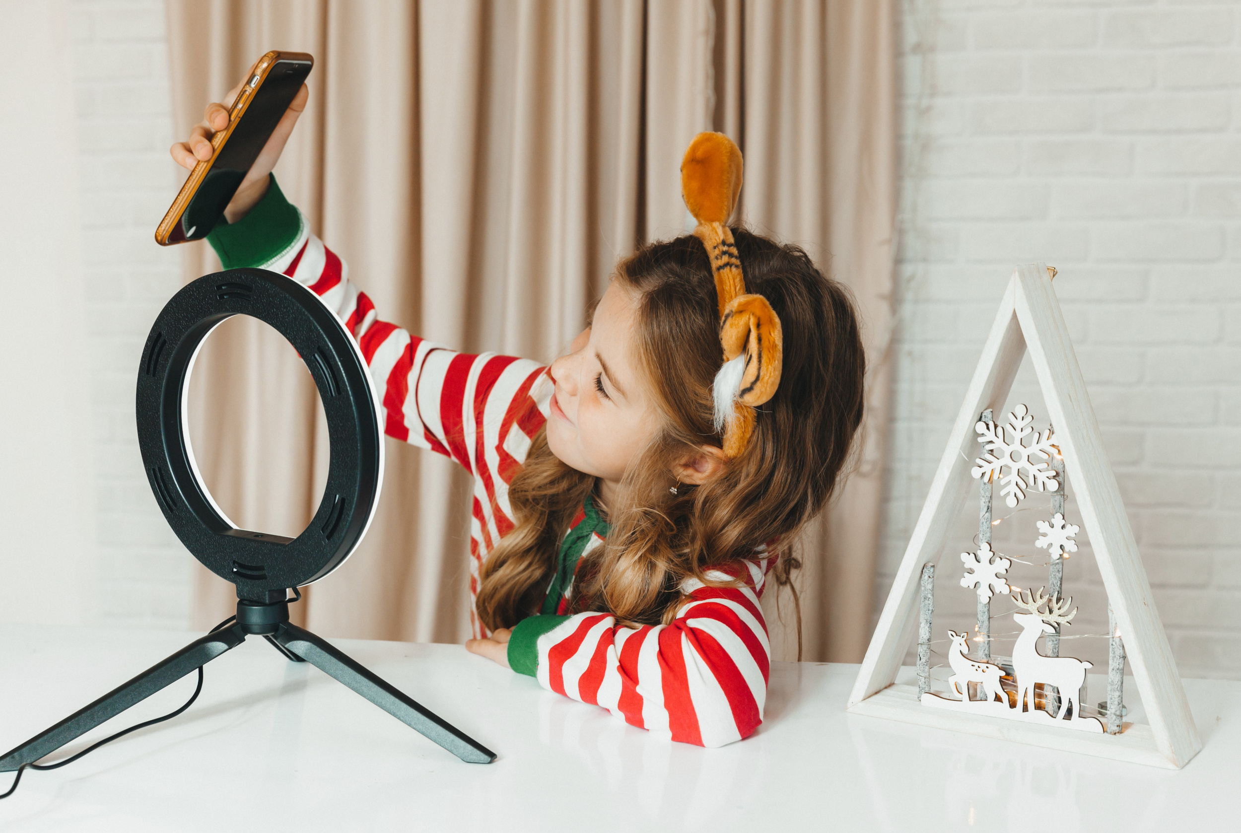 1 teenage-girl-blogging-about-christmas-child-blogger-striped-pajamas-records-video-phone.jpg