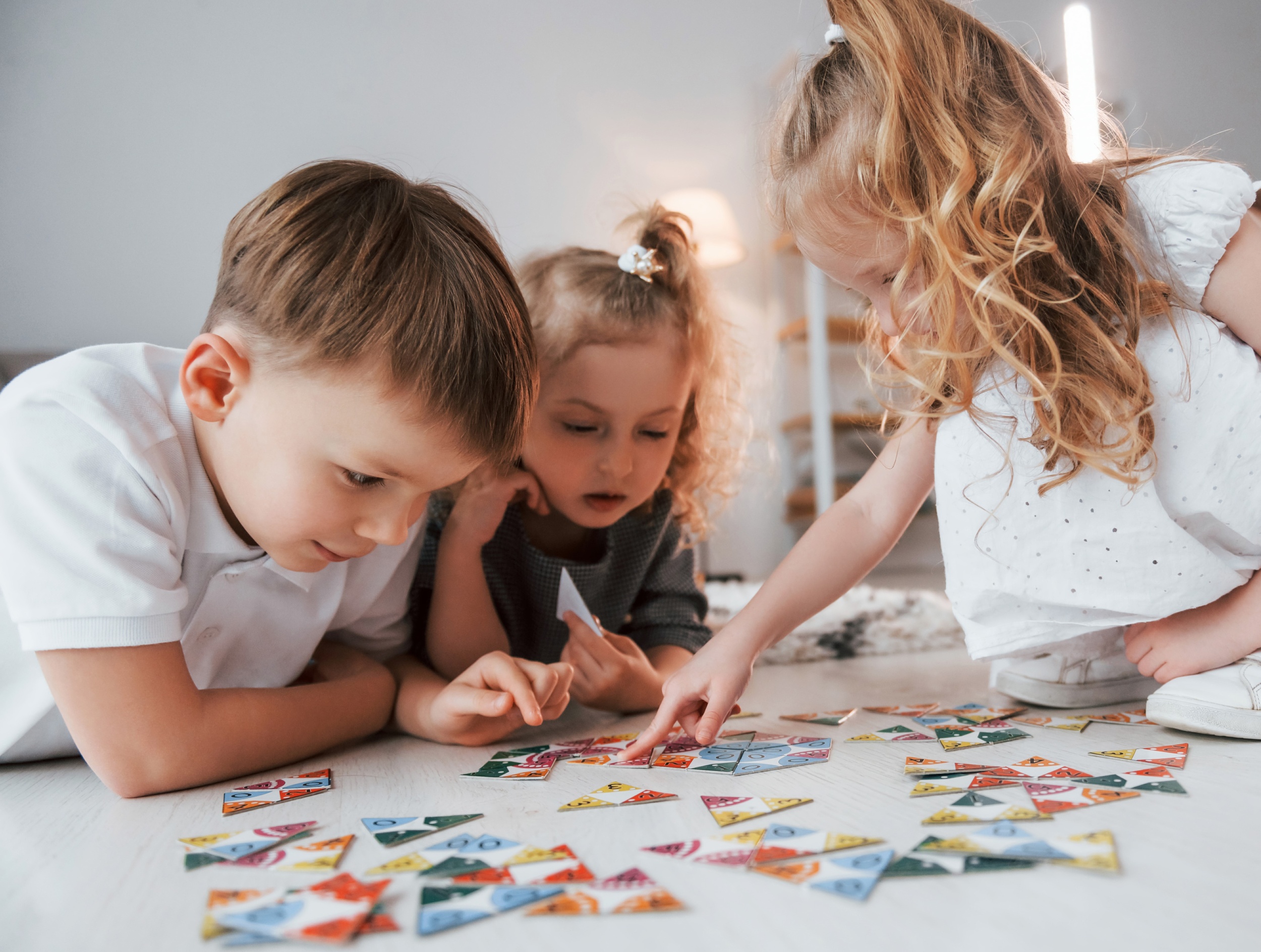 1 sitting-floor-playing-game-group-children-is-together-home-daytime.jpg