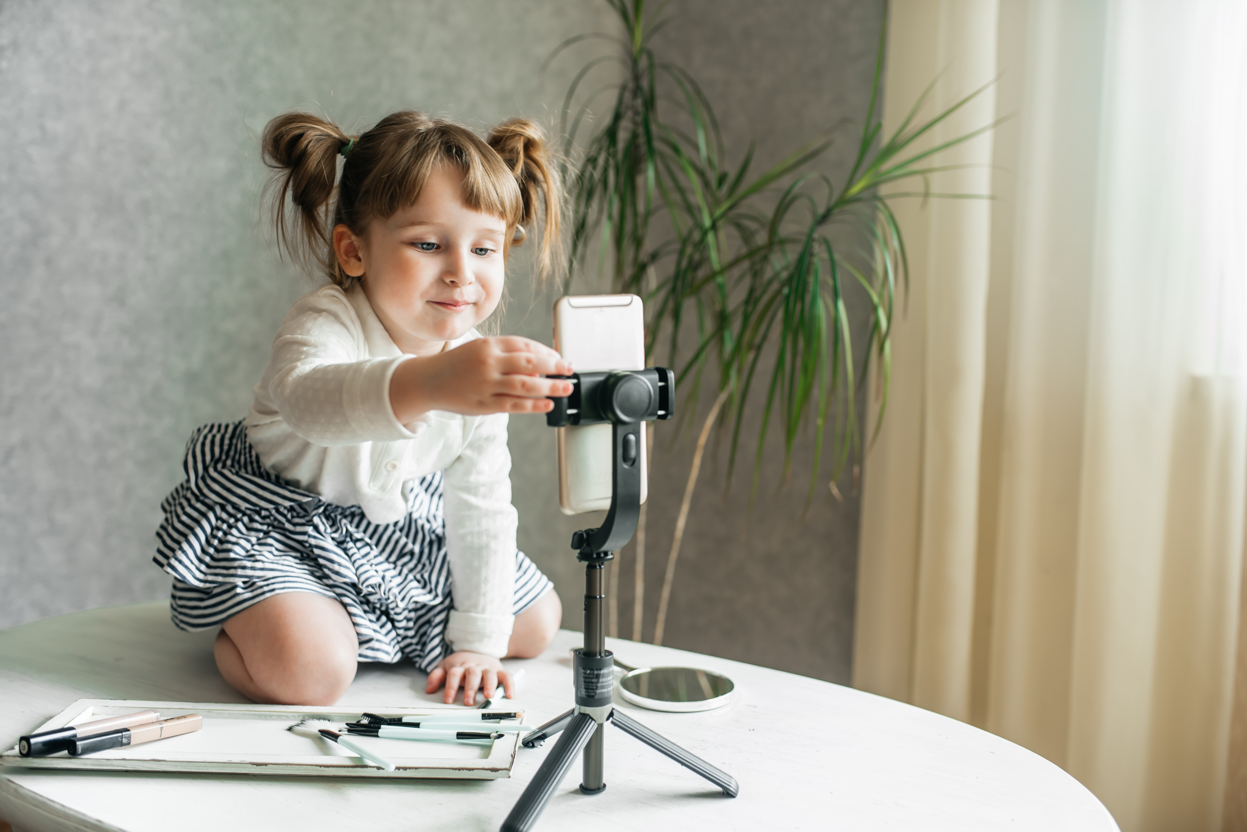 2 cute-caucasian-baby-girl-video-vlogger-phone-tripod.jpg