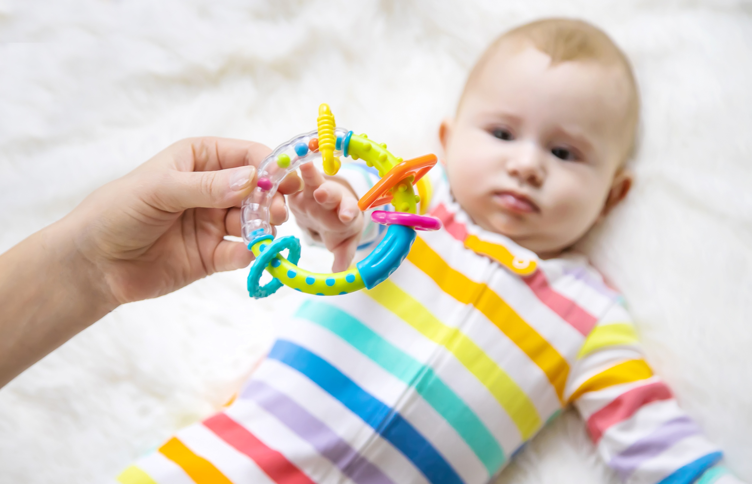 6 mother-holding-toy-while-baby-lying-bed.jpg