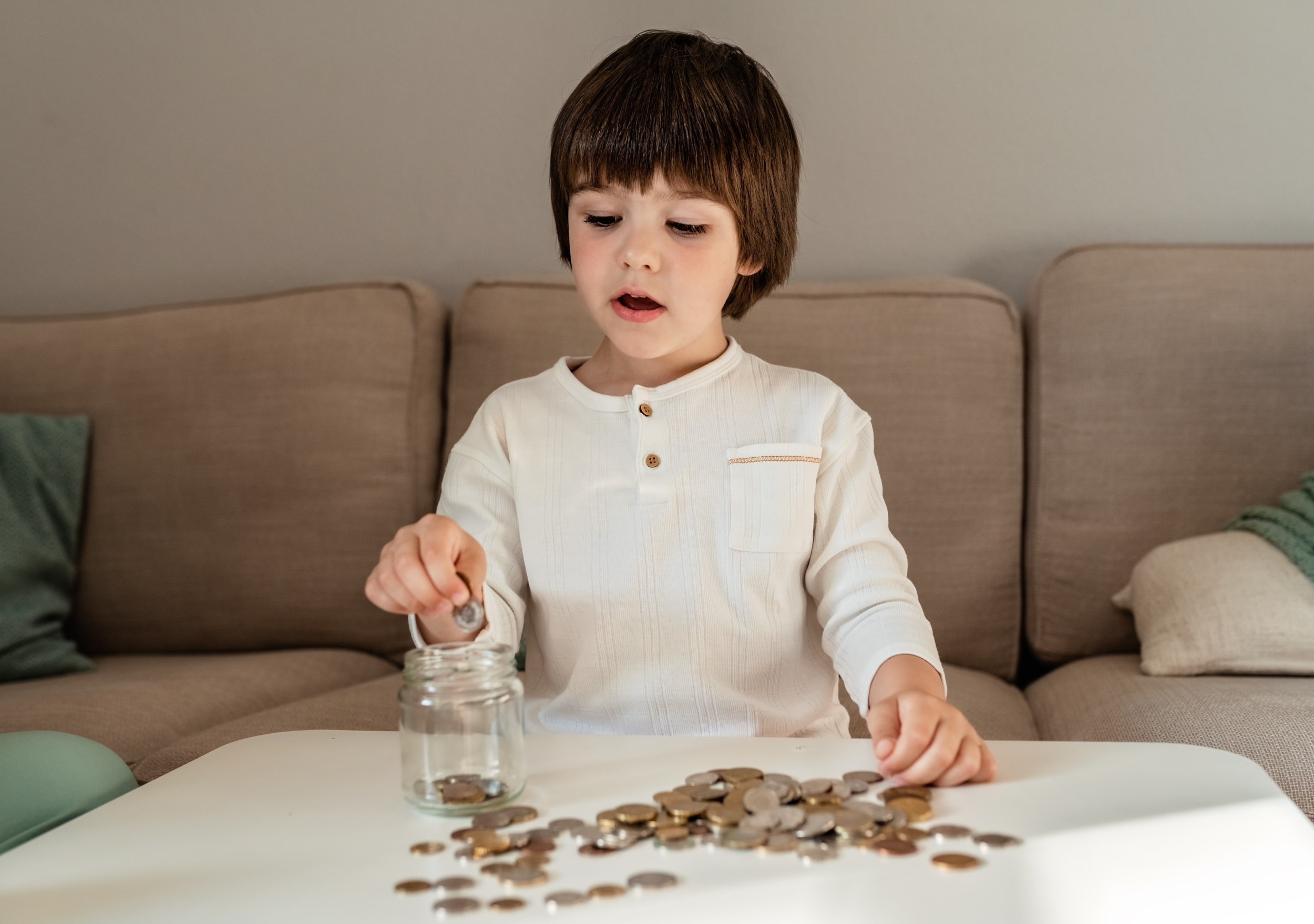 6 little-toddler-boy-counting-money-putting-coins-into-glass-jar-kid-saving-learn-financial-literacy.jpg