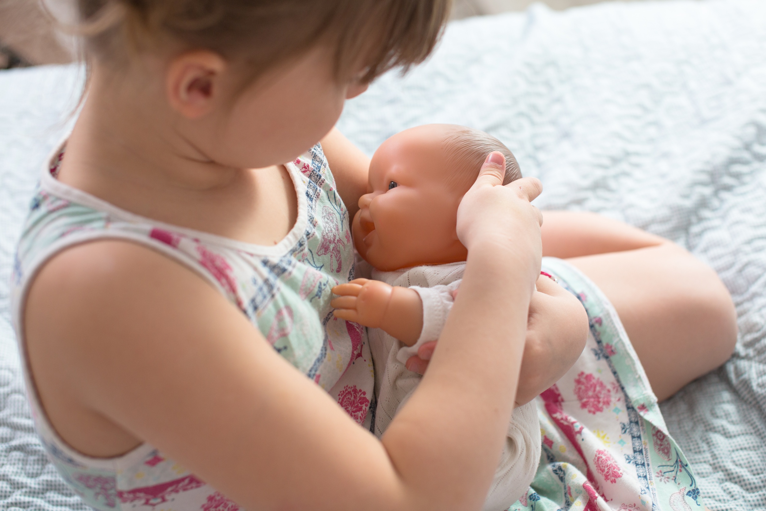 kid-girl-playing-with-doll-breastfeeding-care.jpg kid-girl-playing-with-doll-breastfeeding-care.jpg