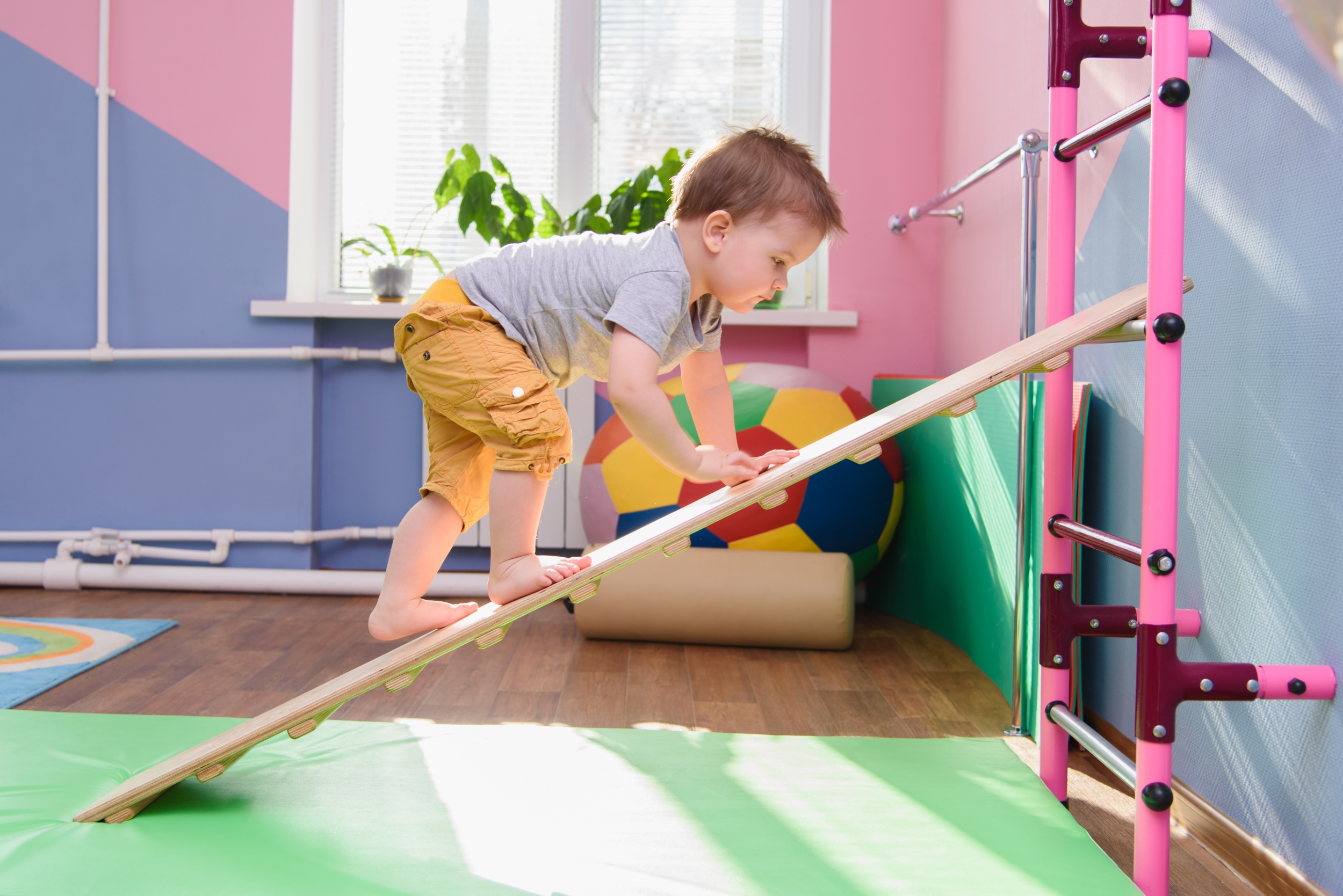 1 little-boy-climbs-up-wooden-plate-gym.jpg